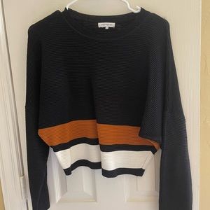 Black, white, gold sweater